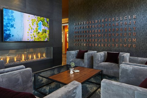 a living room with couches and a table and a fireplace